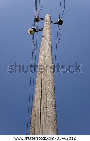stock-photo-old-one-wooden-pillar-with-power-line-blue-sky-35462812.jpg