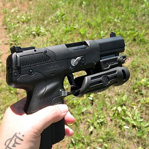FN Fiveseven with a flashlight(?) attached... I think