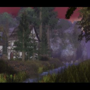 A Shot of a stream bordering a small village and a farm