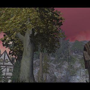 An amazing view of the nearby mountain and village with a slight view of the front of the barn.