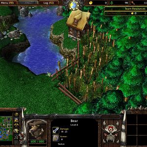 A farmstead with a bear coming from the woods to steal some food.