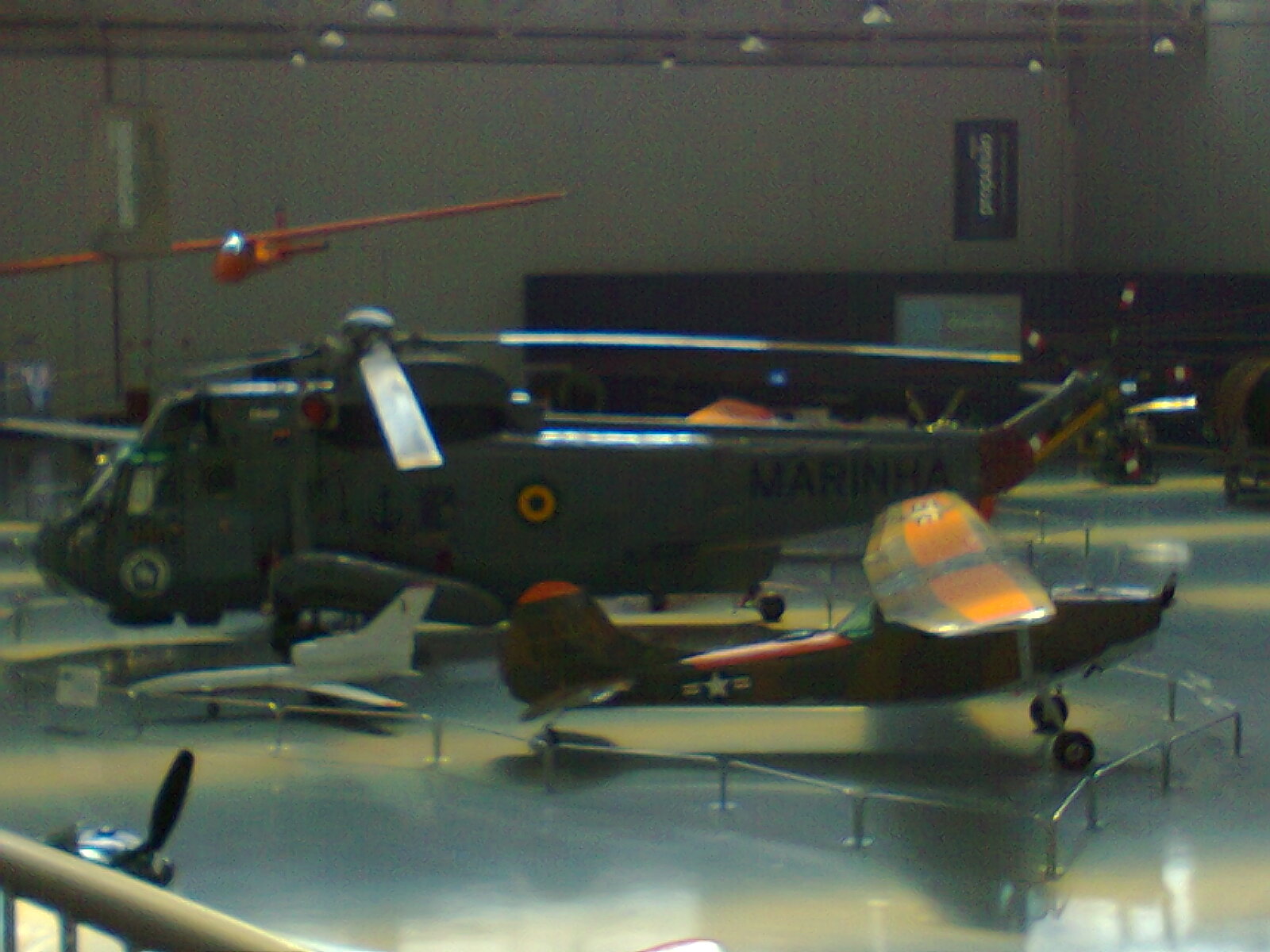Far view of a Sikorsky SH-3 Sea King Helicopter, and perhaps a Cessna.