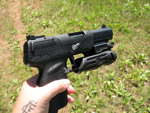 FN Fiveseven with a flashlight(?) attached... I think
