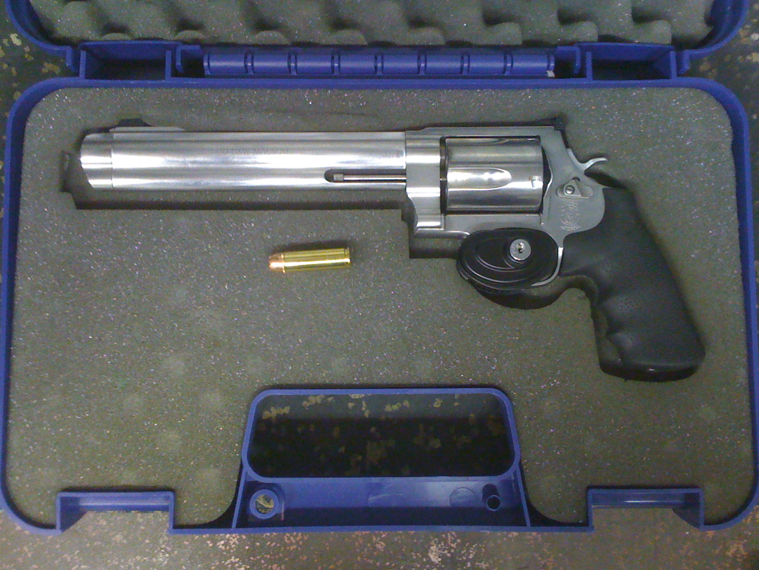 Smith & Wessons Model 500 in case with a .500 Magnum round for comparison